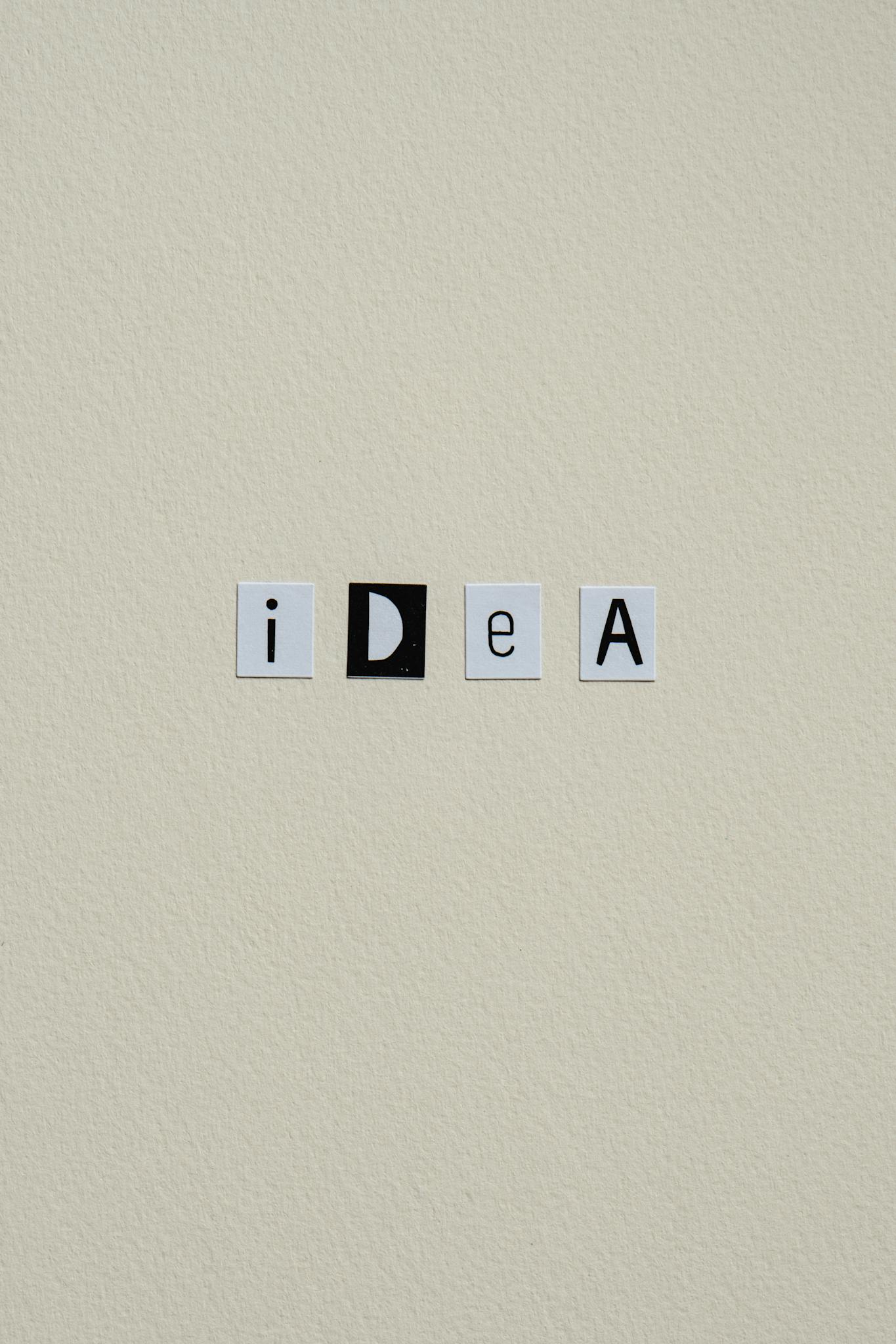 Minimalist design featuring the word 'idea' in mixed fonts on a neutral background.
